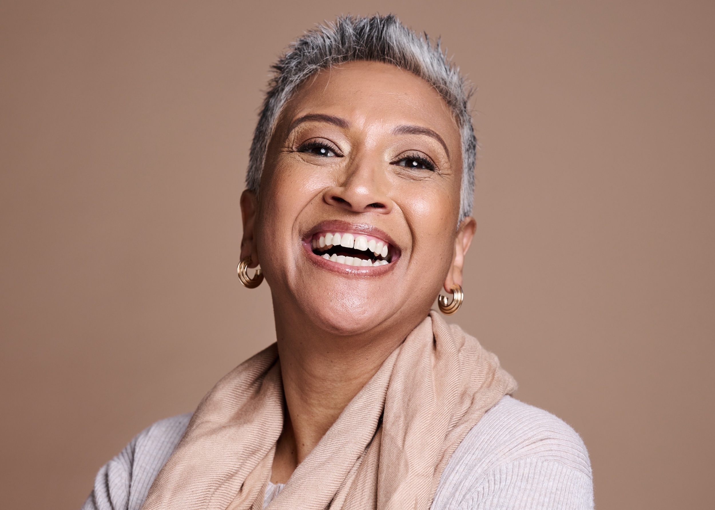Smiling woman with a healthy, confident smile after dental implant treatment
